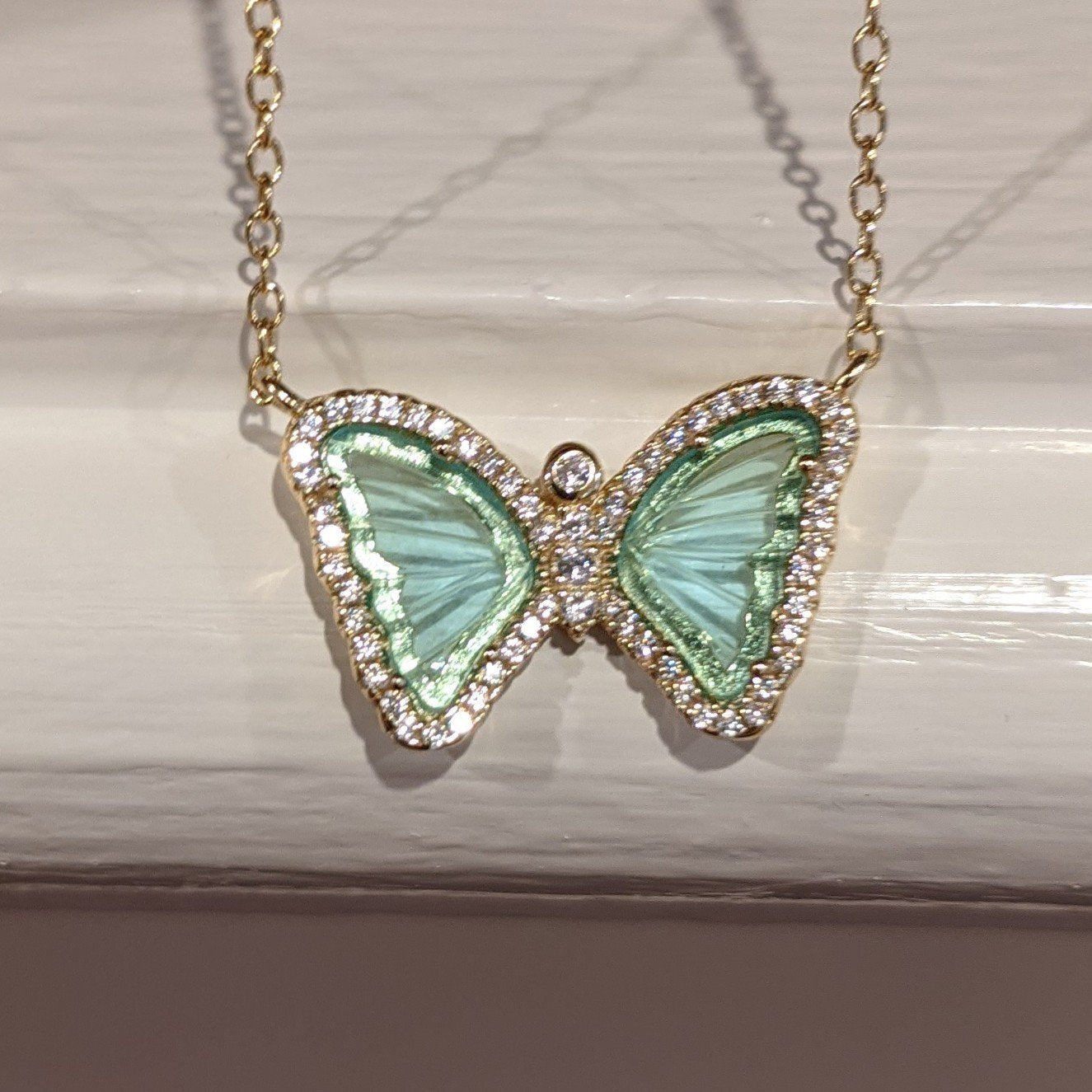Mini gemstone butterfly necklace in aqua green and yellow gold