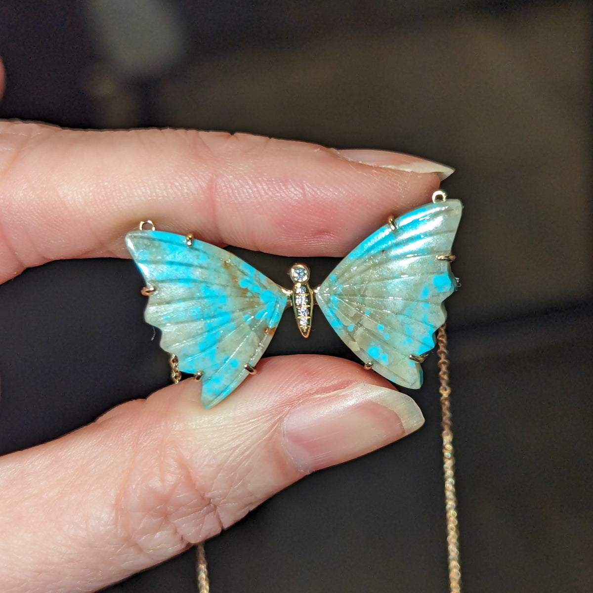 turquoise and tan butterfly necklace with diamonds and prongs