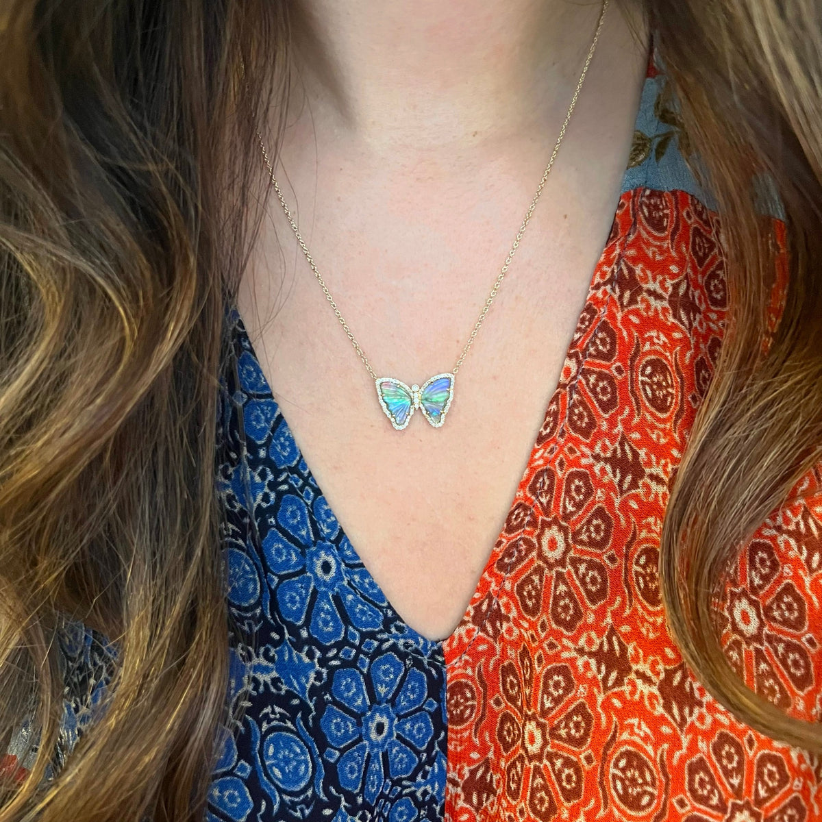 dark blue tourmaline butterfly necklace with pearl and diamonds lifestyle