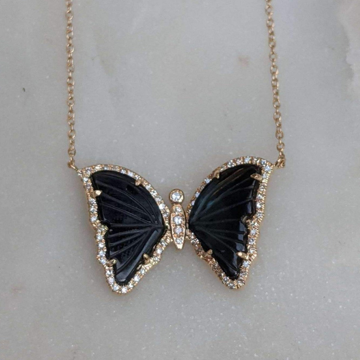 Black Tourmaline Butterfly Necklace With Diamonds on Marble