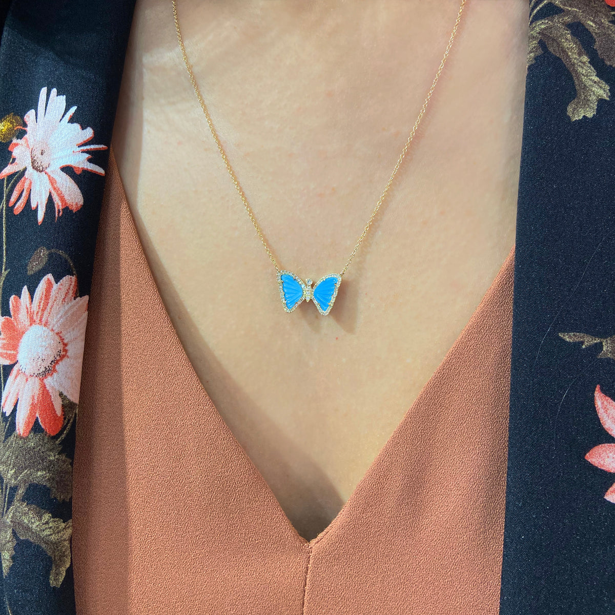 mini butterfly necklace with turquoise in 14k gold lifestyle