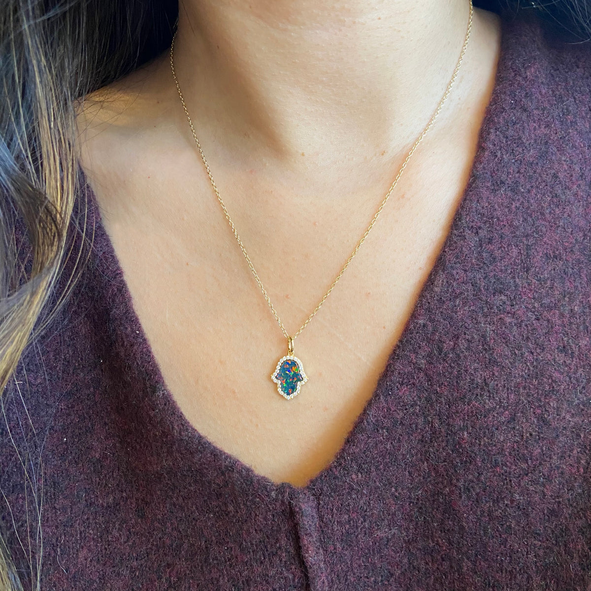 Opal Hamsa hand necklace in black opal