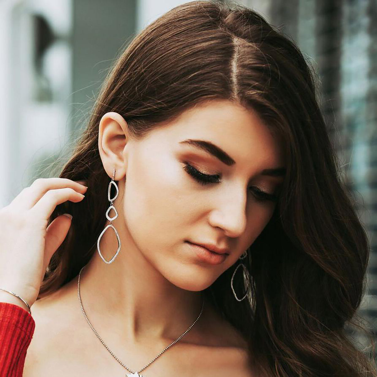 triple organic shape dangle earrings in silver on model