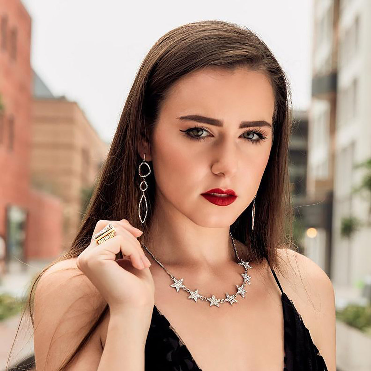 triple organic shape dangle earrings in silver on model