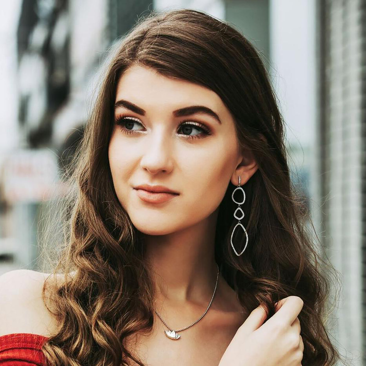 triple organic shape dangle earrings in silver on model