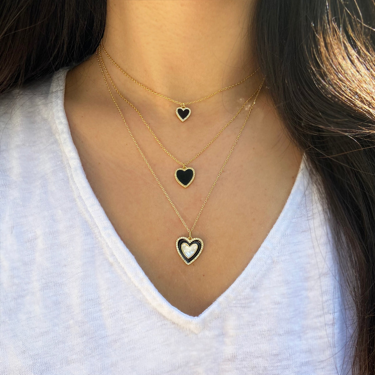 two toned heart necklace with black enamel and onyx layered